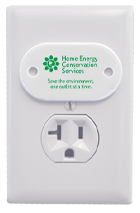 A white SafetyPlug with a green logo on it in a white electrical outlet.